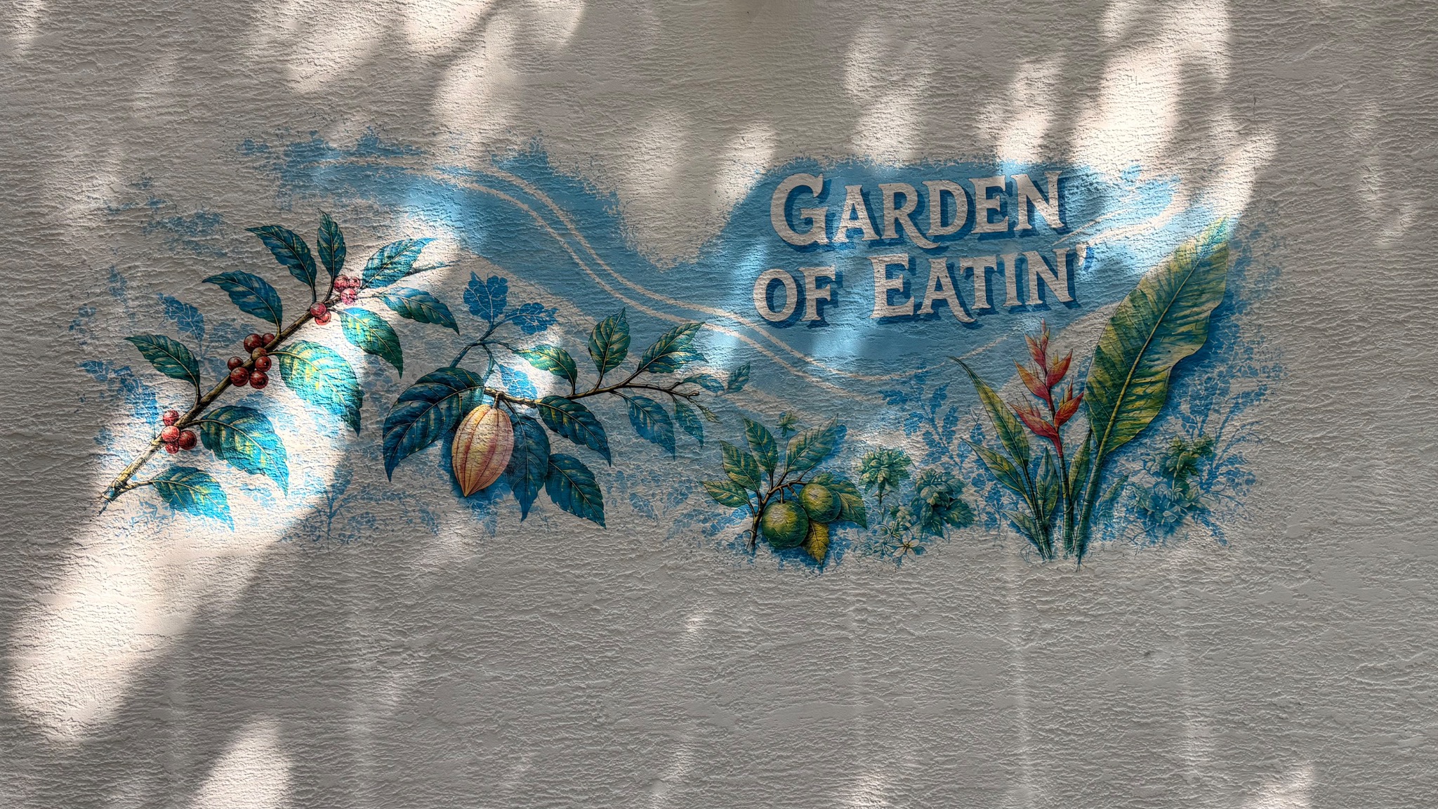 Completed Garden of Eatin' botanical wall print on the exterior stucco wall at Krust Café